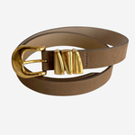 Tan colored belt on plain white background with gold buckle