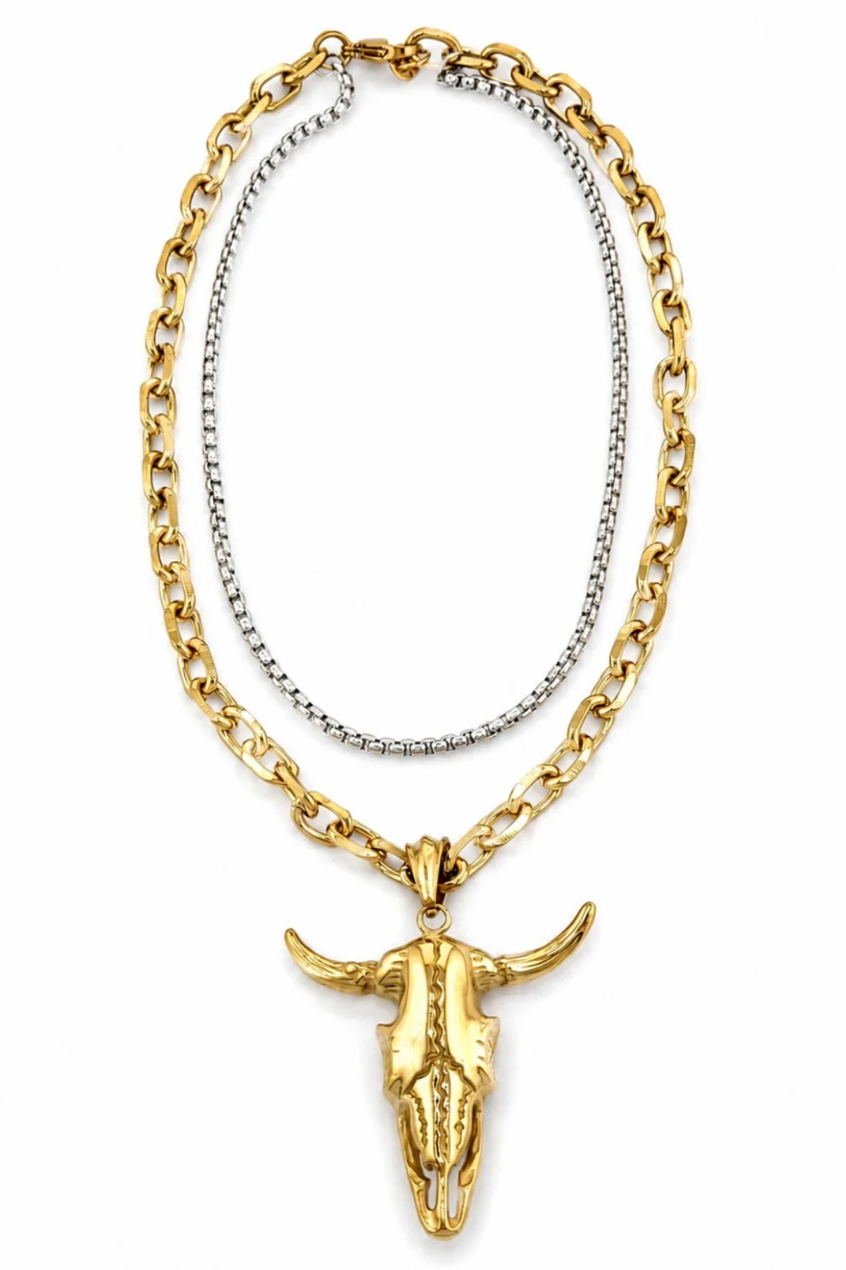 A two-tone necklace featuring a thick gold curb chain and a thinner silver box chain, both adorned with a polished gold bull skull pendant.