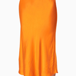 Orange satin skirt worn by a person on a white background