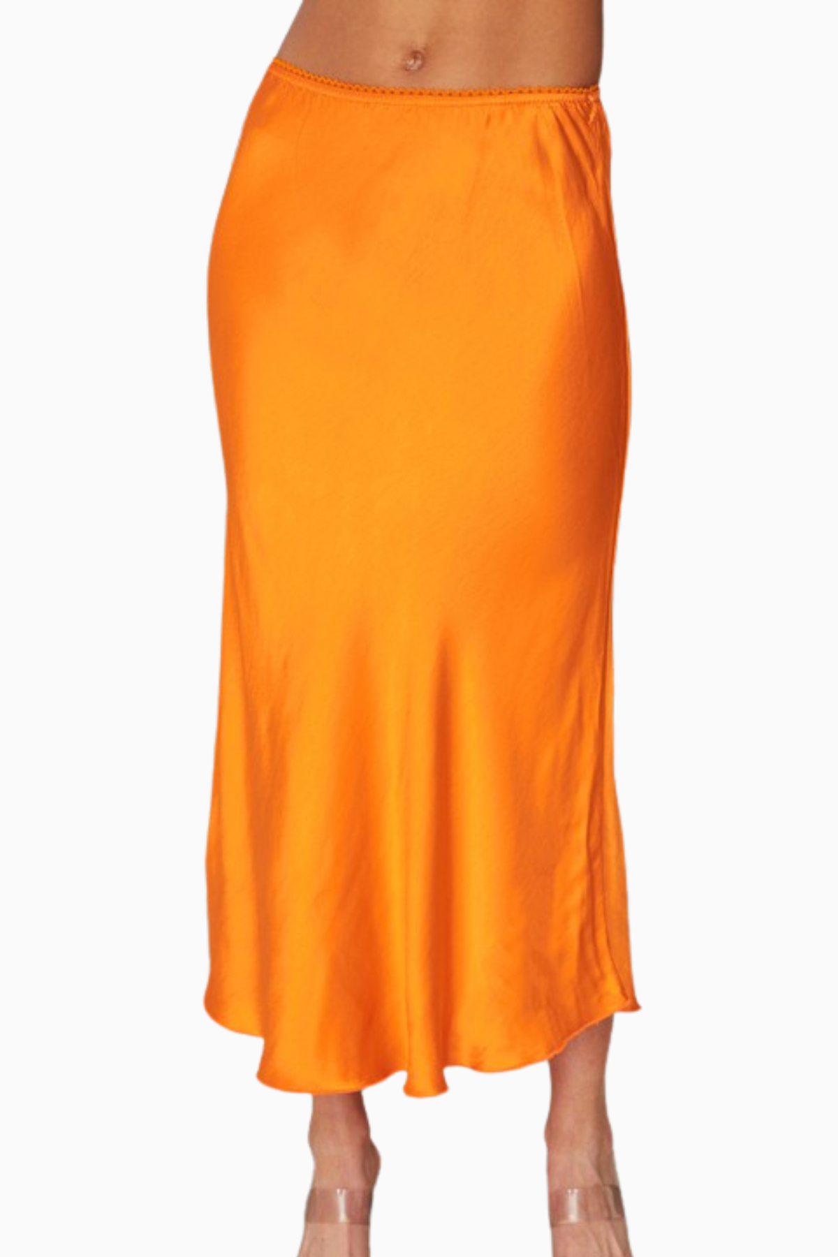 Orange satin skirt worn by a person on a white background