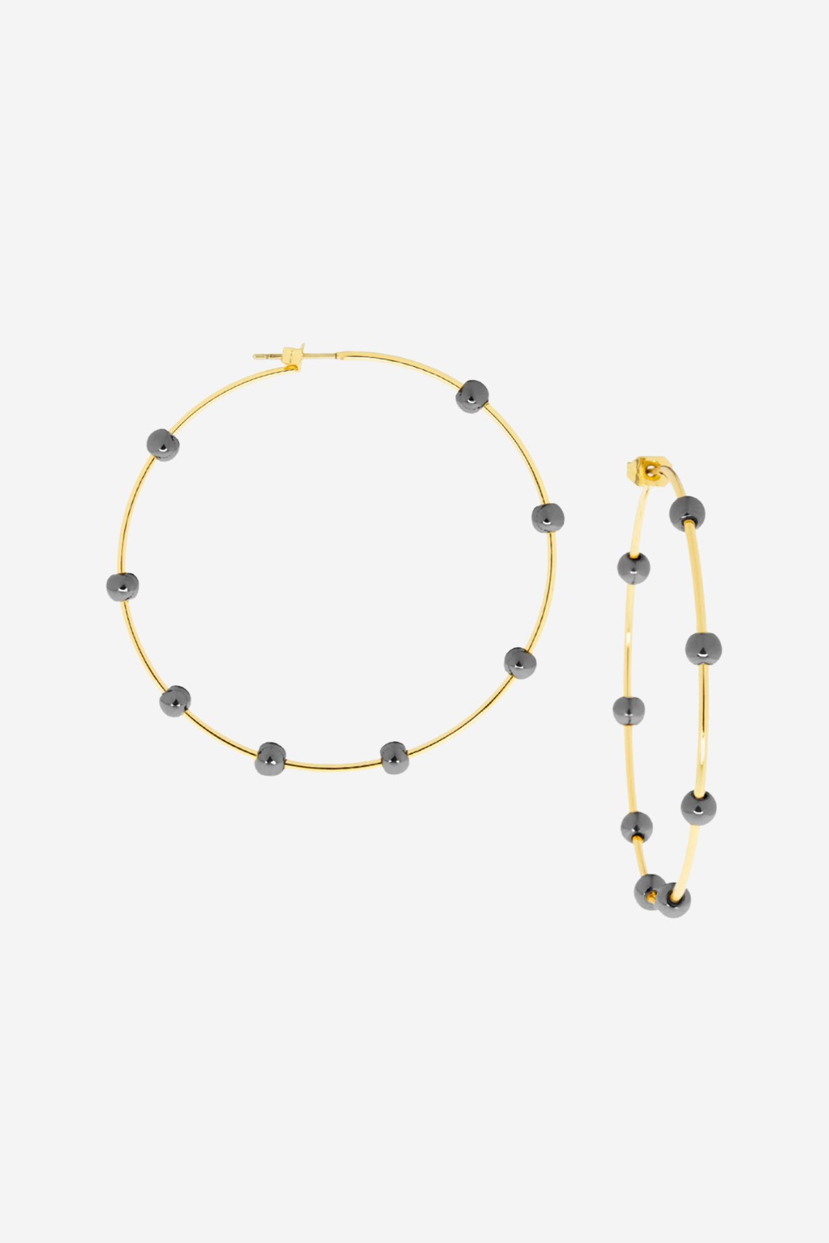 Gold hoops with dark gray beads on a light gray background.
