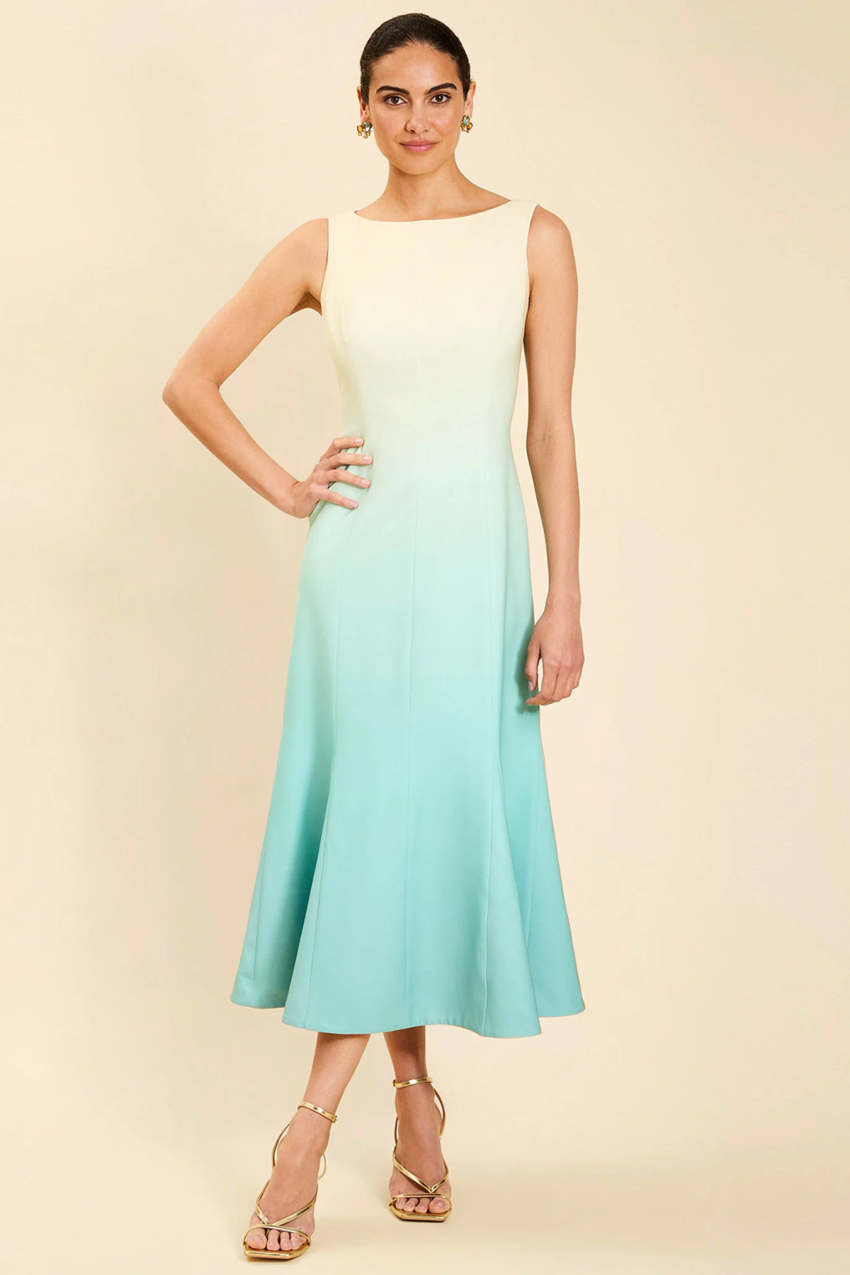 Woman wearing a gradient dress with a beige background