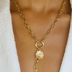model wearing gold chain necklace with medallion 