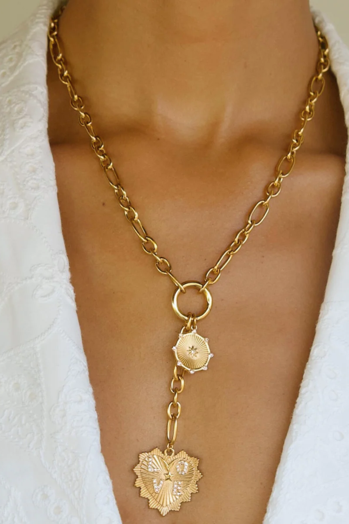 model wearing gold chain necklace with medallion 