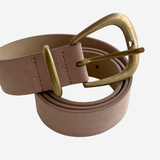 Dusty pink colored belt on plain white background
