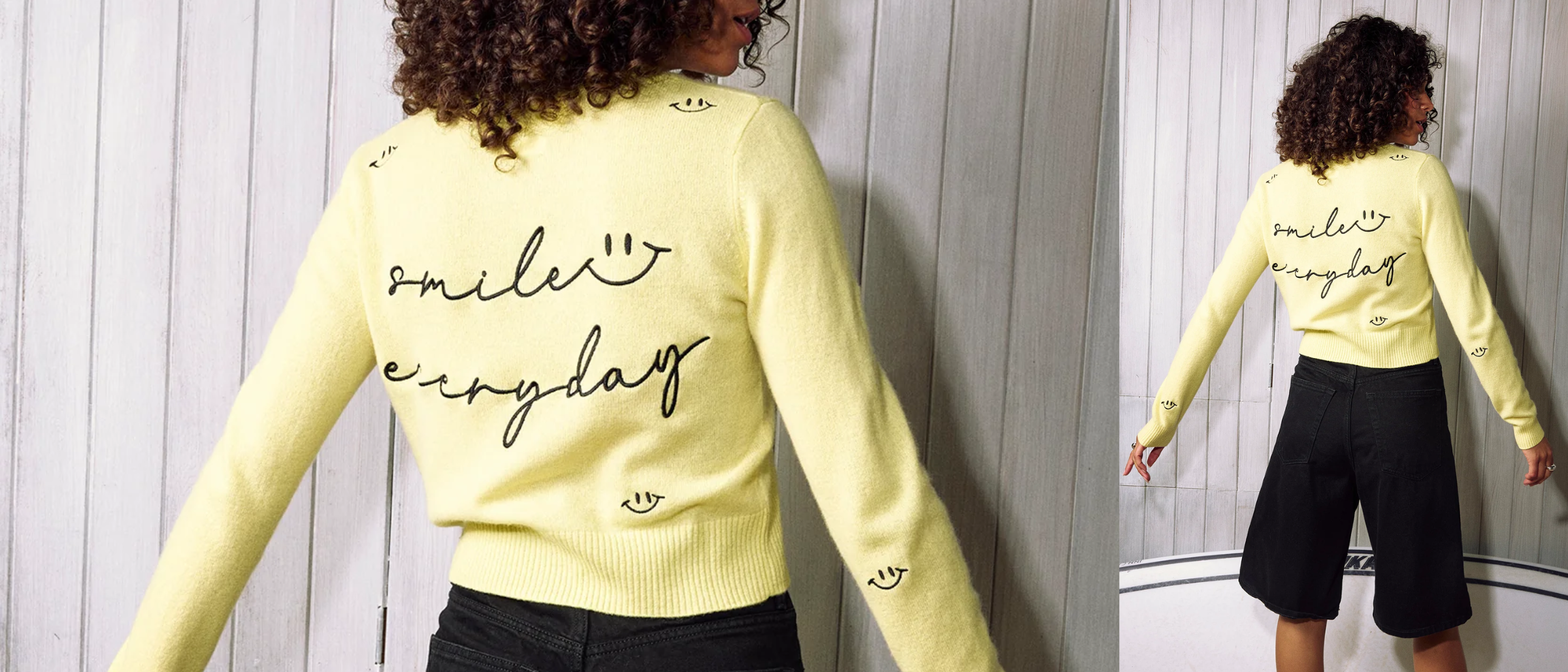 Person wearing a yellow sweater with text, standing against a light wooden panel background.