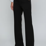 Person wearing black wide-leg pants with a white shirt on a light gray background