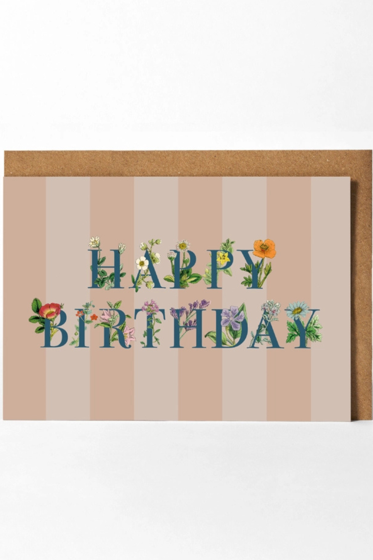 A square birthday card with a kraft envelope, featuring the words 'HAPPY BIRTHDAY' in blue letters decorated with small flowers and green leaves, set against a beige and pink striped background.