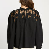 Black blouse with lace details on a white background