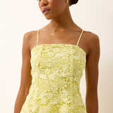 yellow lace top on woman infront of a white background 
