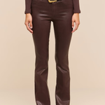 Brown coated boot cut jeans on a beige background.