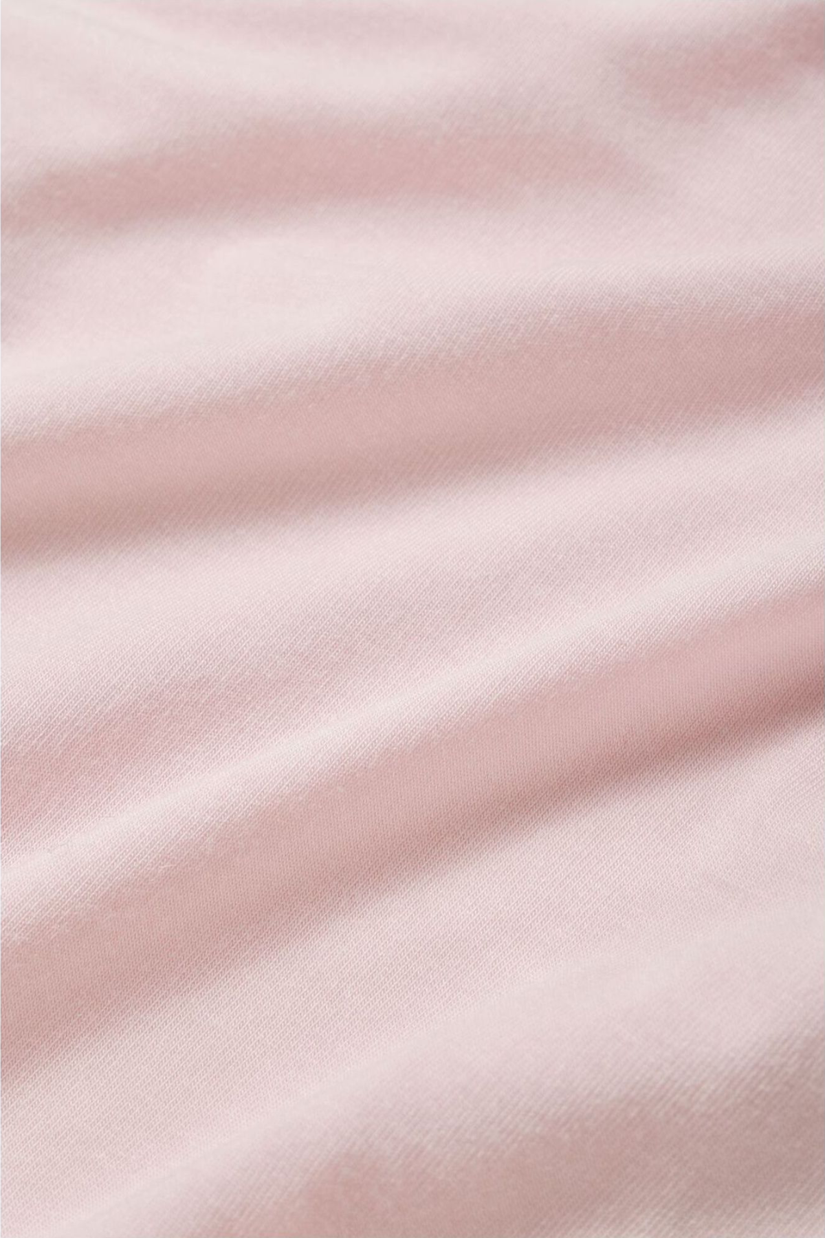 Close-up of soft pink fabric with subtle texture