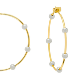 Gold hoop earrings with evenly spaced white pearl-like beads, shown on a clean white background.