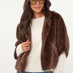 Women's dark faux fur poncho coat featuring a plush textured finish and relaxed draped silhouette.