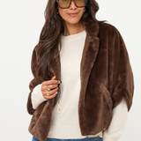 Women's dark faux fur poncho coat featuring a plush textured finish and relaxed draped silhouette.