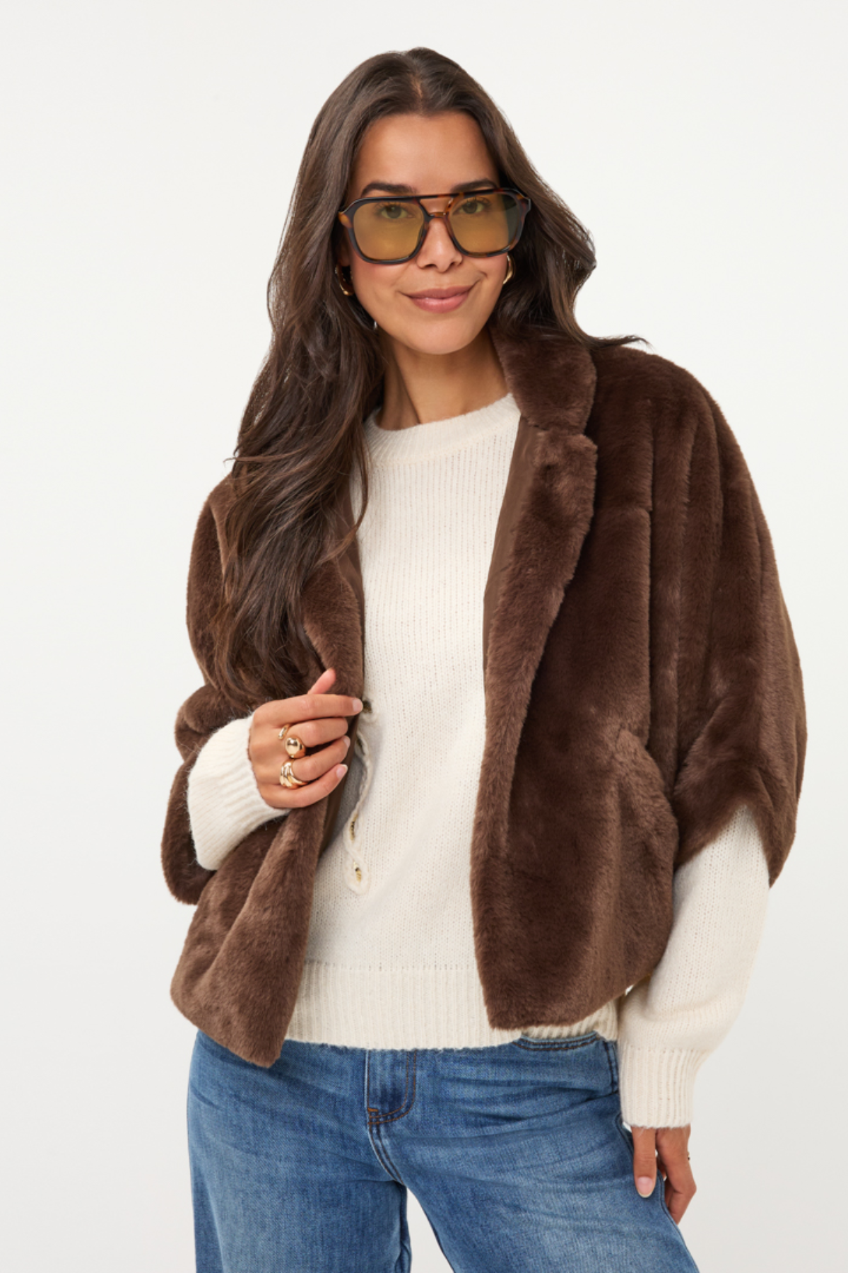 Women's dark faux fur poncho coat featuring a plush textured finish and relaxed draped silhouette.