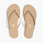 Pair of beige flip-flops on a white background