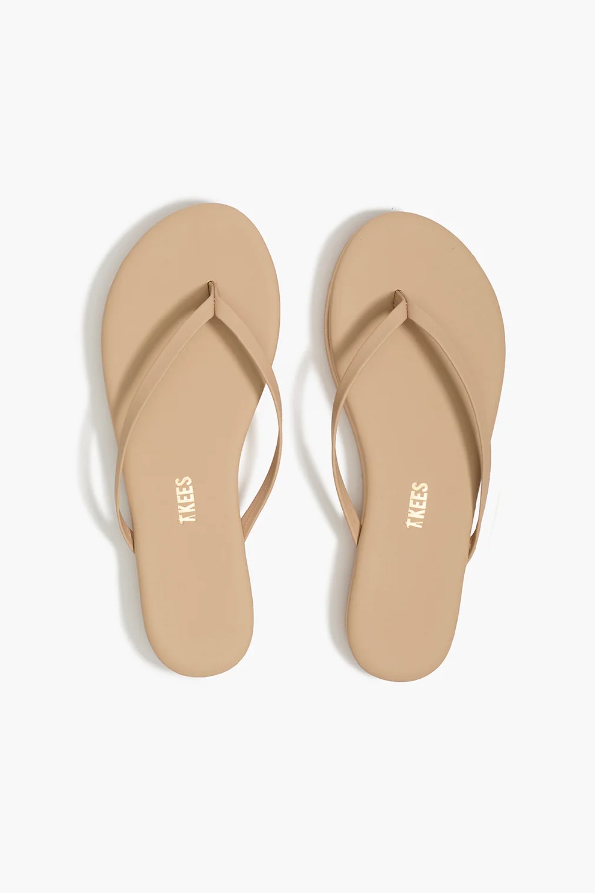 Pair of beige flip-flops on a white background