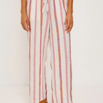 Person wearing a striped outfit with wide-leg pants on a white background