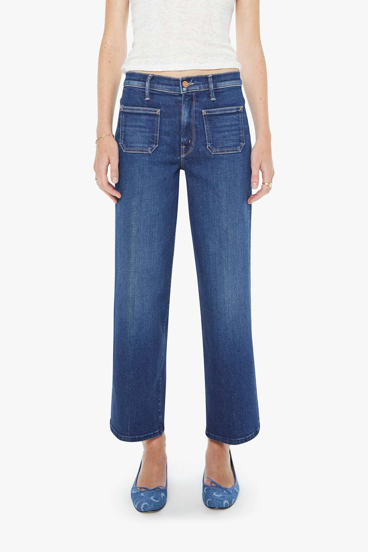 Person wearing blue jeans on a white background