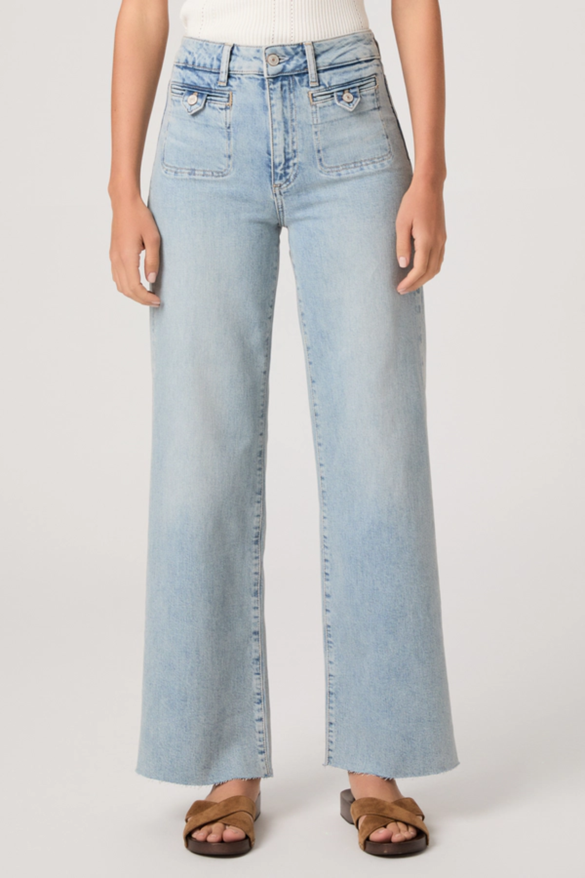 Light blue jeans worn by a person on a white background