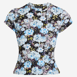 A short-sleeve crewneck top featuring a dense floral print with light blue, lavender, and white flowers on a black background, displayed against a light gray studio backdrop.