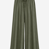 Women's olive green wide-leg palazzo pants featuring a drawstring waist, side pockets, and a relaxed silhouette.