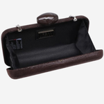 A dark brown textured clutch bag shown open, revealing a black interior lining and a small oval mirror attached to the top clasp. The brand name 'JERSEY' is visible on a small black label inside the lining.