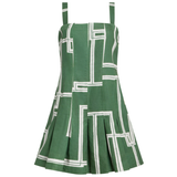 A green sleeveless mini dress with a white geometric line pattern, featuring thin shoulder straps and a flared pleated skirt, shown against a plain white background.