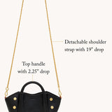 Black Hammitt Paul Mini crossbody bag worn with an evening outfit.