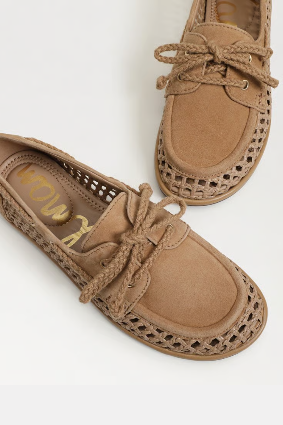 close up of brown flats on white background 