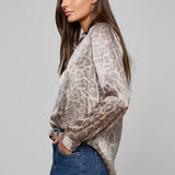 Long-sleeve blouse with a smooth, polished finish.