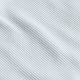 Close-up of a textured white fabric with diagonal lines