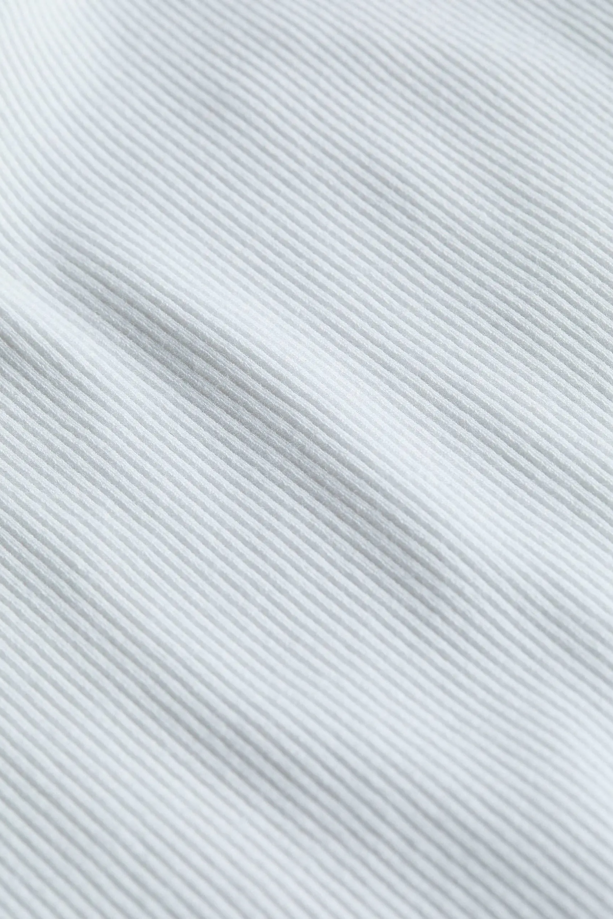 Close-up of a textured white fabric with diagonal lines