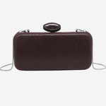 A dark brown textured leather clutch bag with a small oval black handle and a thin silver chain strap, shown against a plain white background.