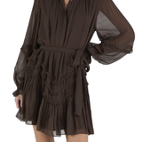 Brown dress with sheer sleeves on a white background
