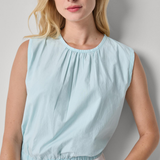 woman in blue sleeveless top on white background 
