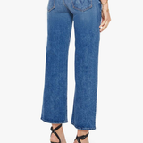 Person wearing blue jeans on a white background