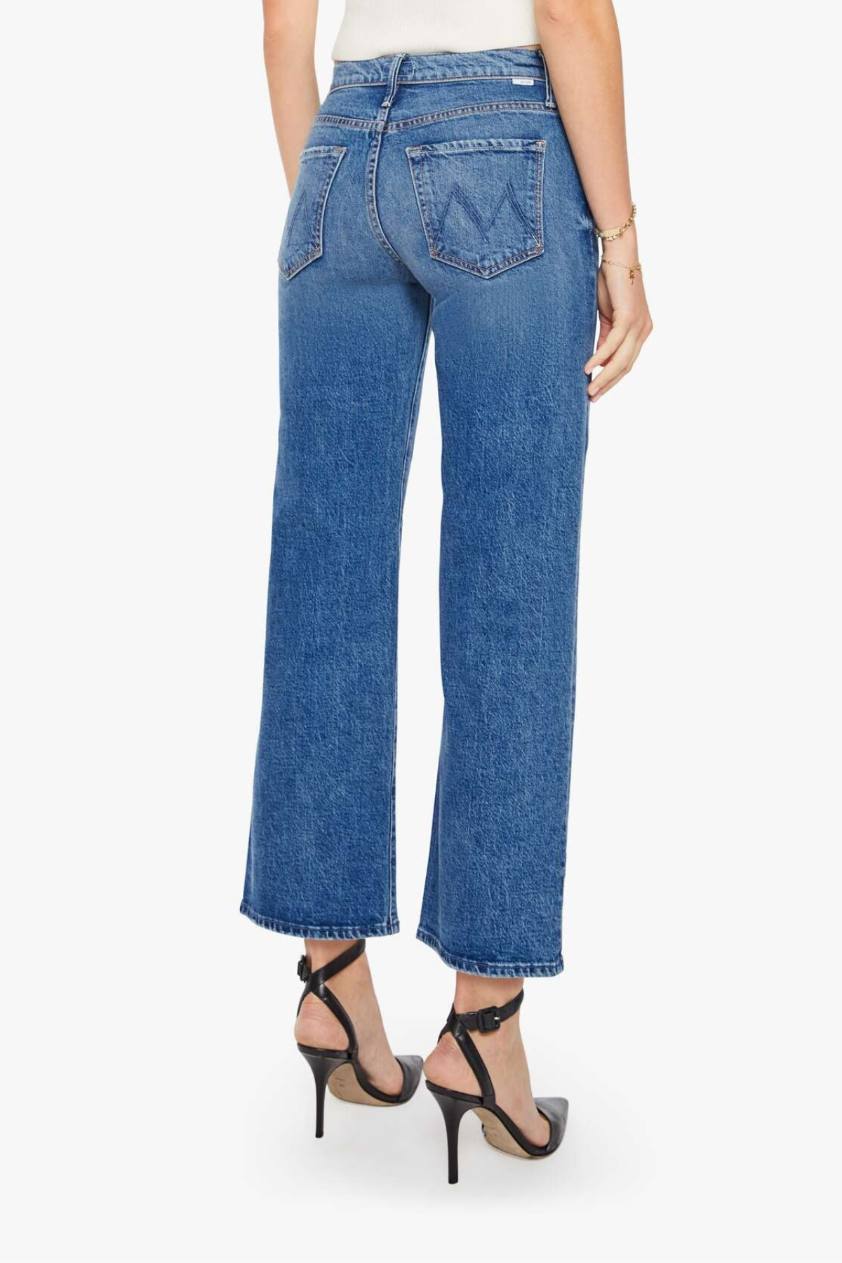 Person wearing blue jeans on a white background