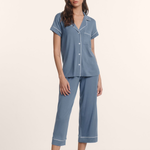 woman in cropped pajama set on tan background 