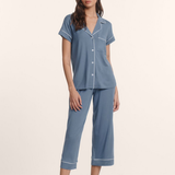 woman in cropped pajama set on tan background 