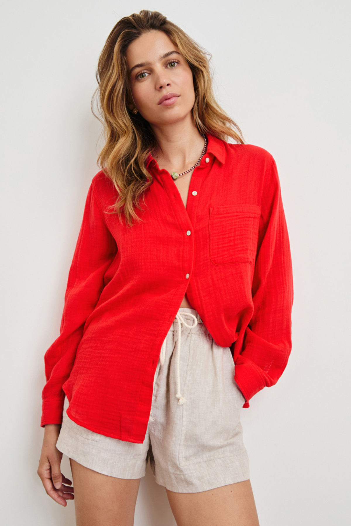 woman in red button down on white background 