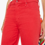 Red pants worn by a person on a white background