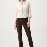 Model wearing slim-fit tailored pants with a streamlined ankle-length silhouette in a classic solid color.
