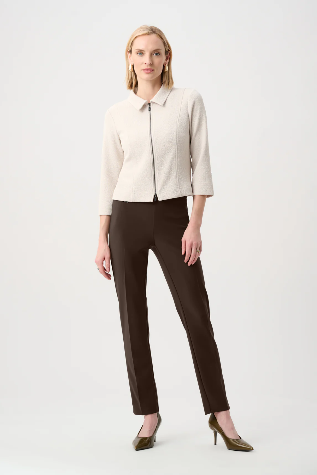 Model wearing slim-fit tailored pants with a streamlined ankle-length silhouette in a classic solid color.