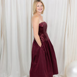 Burgundy sequin dress for evening wear paired with heels