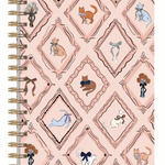 A spiral-bound notebook with a light pink cover featuring a repeating diamond pattern decorated with various illustrated cats in different poses and colors, bound with gold-tone metal coils on the left.