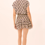 Woman wearing a patterned dress on a white background