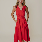 Woman wearing a red dress against a plain background