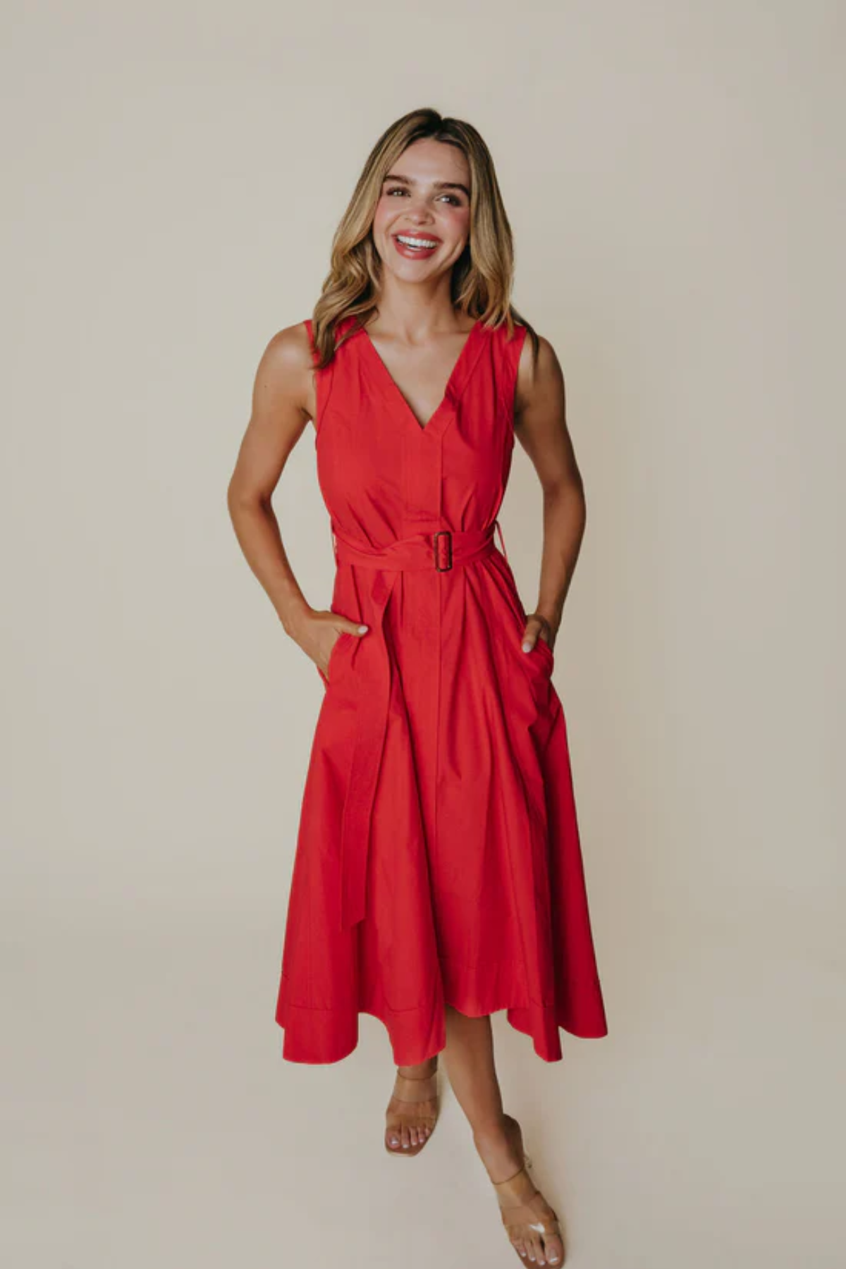 Woman wearing a red dress against a plain background